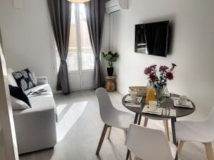 a living room with a table and chairs and a couch at Horizon Plage in Hyères