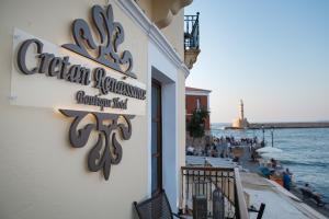 a sign on the side of a restaurant next to the water at Cretan Renaissance in Chania