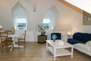 a living room with a couch and a table at La Venelle du Bassin in Honfleur