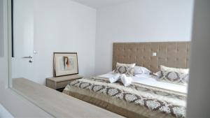 a bedroom with a large bed with a large mirror at Hotel Consul in Split