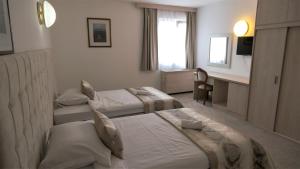 Voodi või voodid majutusasutuse Hotel Consul toas