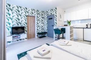 a living room with two beds and a kitchen at RoomService in Bielsko-Biała