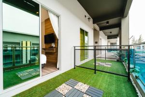 a balcony with a view of a house at SVOK Hotel in Tawau