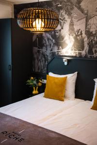 a bedroom with a bed with a poster on the wall at Hotel Riche in Valkenburg