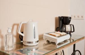 a kitchen counter with a coffee maker and a toaster at El Nogal Home in Málaga