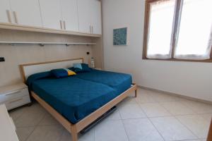 Postel nebo postele na pokoji v ubytování La Terrazza - Splendido trilocale a Lacona