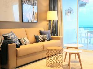 a living room with a couch and a table at Sitges Spaces Sea View Paradise 5 min from Balmins in Sitges +17 photos