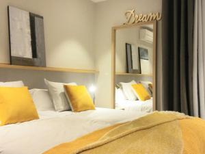 a bedroom with two beds and a large mirror at Sitges Spaces Sea View Paradise- 2 Bedrooms, 2 Bathrooms, Terrace, Amazing Sea Views in Sitges +17 photos