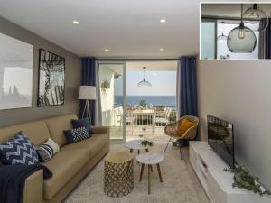 a living room with a couch and a view of the ocean at Sitges Spaces Sea View Paradise 5 min from Balmins in Sitges