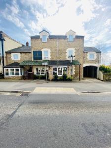 a large brick building with a garage on a street at Mount Pleasant Hotel in Oxford