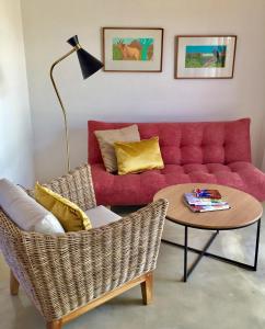 a living room with a red couch and a table at Darling Lodge Guest House in Darling