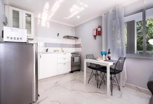 a kitchen with a table and chairs and a refrigerator at Peponi SelfCatering Apartments in Beau Vallon