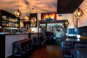 a bar with chairs and tables in a restaurant at LivInn by Trotmannia in Dortmund