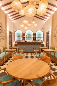 a restaurant with tables and chairs and a bar at The Merchant in Galle +37 photos