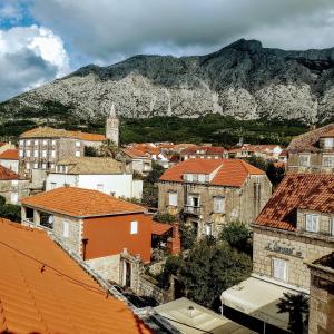 a city with buildings and a mountain in the background at Spacious garden house, Orebić (4+1) in Orebić