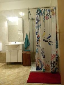 a shower curtain in a bathroom with a sink at Spacious garden house, Orebić (4+1) in Orebić +33 photos