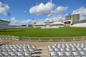 a stadium with white seats and a green field at Lady Bay Apartments in Nottingham
