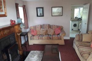 a living room with a couch and a fireplace at 2 bed house at Ballycastle seafront in Ballycastle