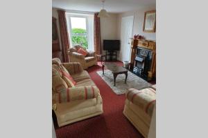 a living room with two couches and a fireplace at 2 bed house at Ballycastle seafront in Ballycastle