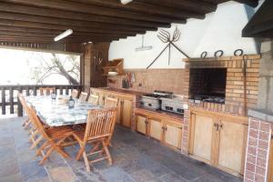 a kitchen with a table and a stove top oven at La Casona Del Almendro in San Bartolomé de Tirajana