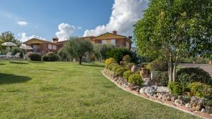 a yard with a house in the background at VILLA GABRI 8&2, Emma Villas in Montecarlo