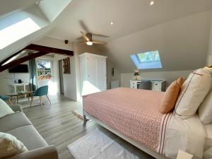 a bedroom with a bed and a couch at Sans Souci Bed and Breakfast Luxe Heated Pool and Restaurant in Luzillé