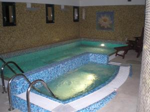 a large swimming pool in a room at Casa Ninfea Panzió in Cserszegtomaj