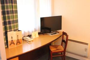 a desk with a computer and a monitor on it at Campanile Hotel Wakefield in Wakefield