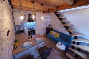 a small living room with a blue couch and a staircase at La Corte di Kate in Biograd na Moru