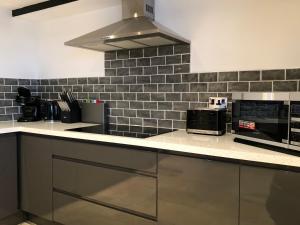 a kitchen with a counter top with a microwave at Harbourside in Staithes