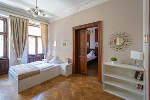 Schlafzimmer mit einem Bett und einem Spiegel in der Unterkunft For celebrations spacious 3BDR apartment with balcony in Prag