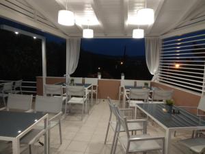 a restaurant with tables and chairs and a view at De Sol in Limenaria