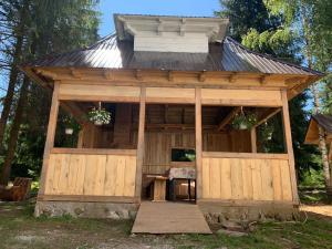 a large wooden cabin with a tin roof at Pensiunea Valea Pintei in Vatra Dornei