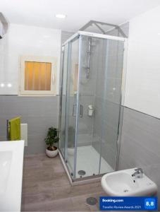 
a bathroom with a shower, sink, and toilet at domus bianchi in Naples

