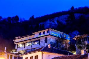 a building on top of a mountain at night at Hotel Melnik in Melnik