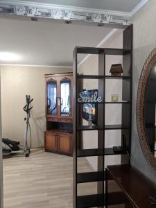 a room with a mirror and a shelf with a smile sign at Apartment with balcony on Peremohy Avenue 43 in Chernihiv