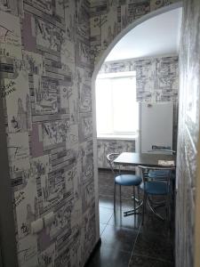 a dining room with a table and a wall covered in drawings at Apartment with balcony on Peremohy Avenue 43 in Chernihiv +29 photos
