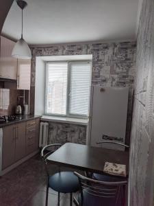 A kitchen or kitchenette at Apartment with balcony on Peremohy Avenue 43