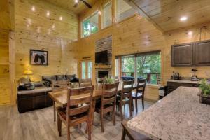 a kitchen and dining room with a table and chairs at Luxury 5bed/6ba Cabin: Theater, Pool Room, Hottub! in Gatlinburg