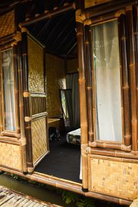 a reflection of a room in a mirror at Paddies Homestay New in Cipaku-gede
