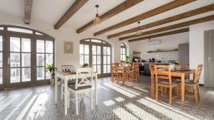 a kitchen and dining room with wooden tables and chairs at Premium Vendégház in Eger