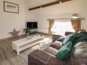 a living room with a couch and a coffee table at Fields Farm in Draycott in the Moors