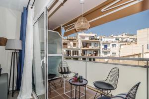 a balcony with chairs and a table at Sitges Spaces Deluxe Centre Apartment in Sitges