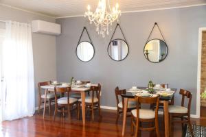 a dining room with tables and chairs and mirrors at Pousada Catedral in Canela