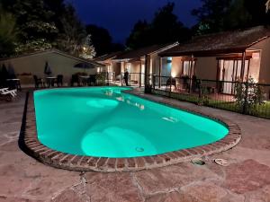 a swimming pool in a yard at night at Mont Blanc in Villa General Belgrano
