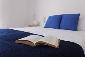 um livro aberto sentado em cima de uma cama em Casas d'Almofala em Vila de Rei