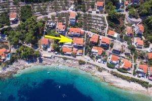 an aerial view of a beach with a yellow arrow at Apartments Andrijic in Prigradica