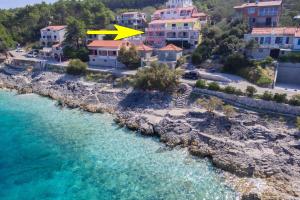 - une vue aérienne sur une plage avec des maisons et l'eau dans l'établissement Apartments Andrijic, à Prigradica