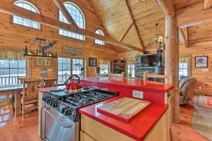 a kitchen with a stove top oven in a cabin at Poconos Family Fun Waterfront Cabin with Deck! in Nay Aug