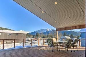 a patio with a table and chairs on a deck at Mendenhall Valley Escape with Furnished Deck! in Juneau
